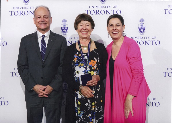 2016 Kathy poses at 50th with UofT Pres & Pres of
          Alumni