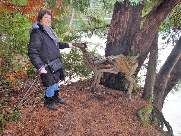 2017 Kathy stands by an unusual sculpture at Montegue HBR
        on Galiano