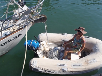 Kathy in our
            Carib 9ft Utralite dinghy and 15 HP Yamaha outboard