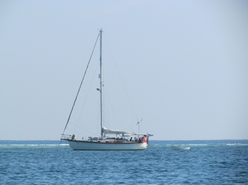 Magdelana with Casey and Jamie aboard anchored off SW
            Cay at Glovers Reef