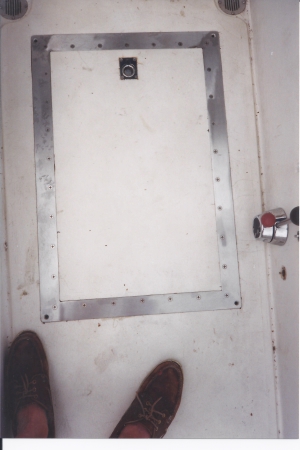 A hole was cut in the
        cockpit floor to provide better access to the rear of the engine
        and rudder